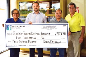 Bridge Capital Jody Jordahl, second from left, presents a $3,000 donation to special assistant for Project Development Vicky Benavente, acting governor Steve Mesngon, and MTEC board member and tournament director James Nelson for the 2nd Annual Governor's Tourism Cup to benefit MTEC. (Contributed Photo)