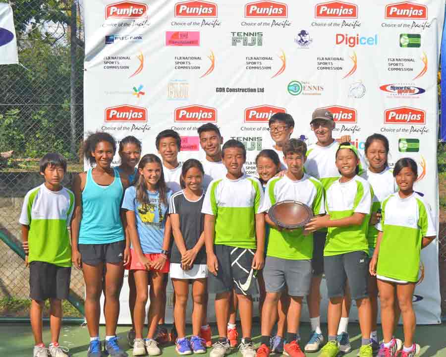 The CNMI Junior Tennis Team and coach Jeff Race pose with their Nation’s Cup award during last year’s 2016 Pacific Oceania Junior Championships in Fiji. (Contributed Photo)