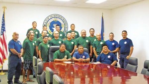 Gov. Ralph DLG. Torres and Department of Fire and Emergency Medical Services assistant fire chief Jesse Mesa pose in a group photo with members of the 15-man crew as well as DFEMS officials/trainers during a press conference yesterday at the governor’s office’s conference room. The crew members will be deployed to California to assist in fighting forest fires. (Ferdie de la Torre)
