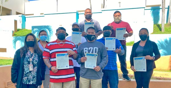 Seven individuals from the community show off their certificates on Aug. 25.