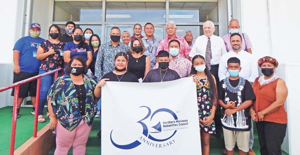 Gov. Ralph DLG Torres and Lt. Gov. Arnold I. Palacios share a photo with members of the Northern Marianas Humanities Council 