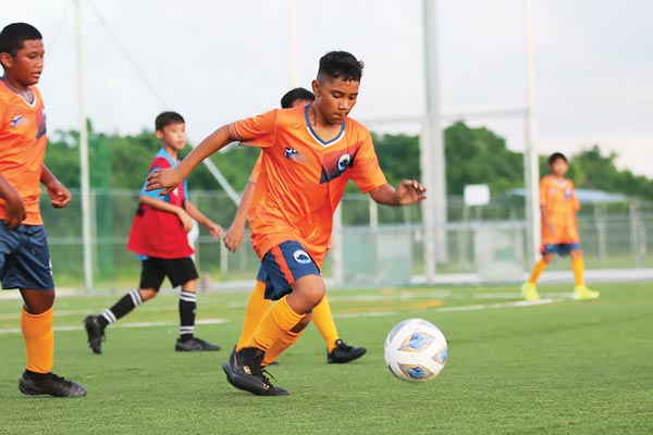 A Tanapag Middle School player dribbles during their game against Mt. Carmel School in the opening of the NMIFA-PSS Interscholastic Soccer League 2021-2022