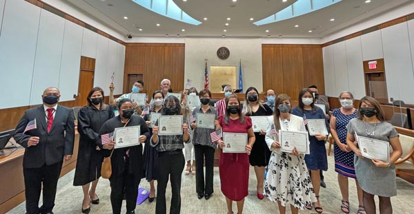 U.S. District Court for the NMI Chief Judge Ramona V. Manglona, second from left, poses with the new citizens and Dr. Jonathan Liwag after yesterday’s swearing in ceremonies at the U.S. Courthouse