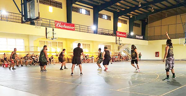 Team CNMI and RNV Construction players in action Wednesday night in the 2021 Island-wide Men’s BudLight Basketball League.