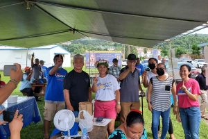 After visiting the tent of the Republican Party, Lt. Gov. Arnold I. Palacios proceeds to the tent of the Democratic Party
