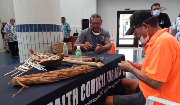 John Castro, middle, and a colleague make rope using coconut fibers. 