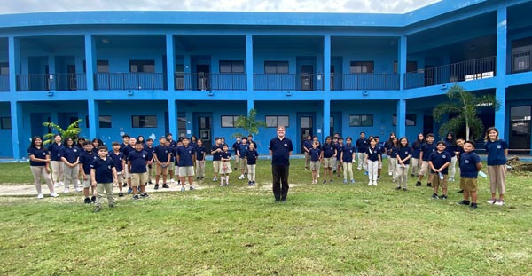Mount Carmel School band director Julian Greening takes a group photo with all student members