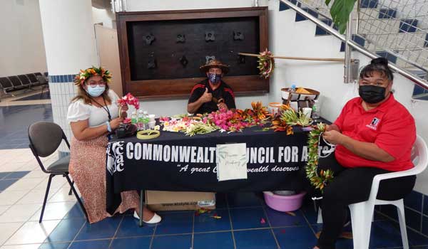 Members of the Commonwealth Council for Arts & Culture share a photo at their table where they demonstrated how to make mwaars