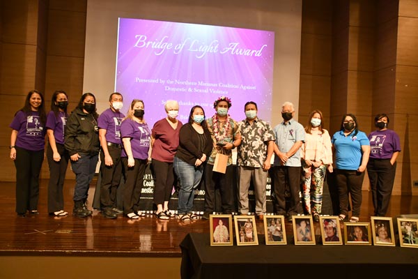 Karidat Social Services advocate Calvani P. Deleon Guerrero, sixth from right, receives the 2021 Bridge of Light Award