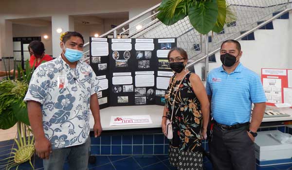 NMI Museum of History and Culture docent Archie Ajoste, leftmost, shares a photo with colleagues at the museum’s table