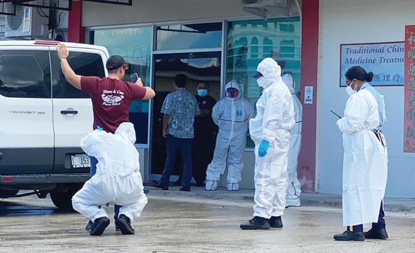 Department of Public Safety officers in hazmat suits arrest freelance photographer David Butterfield who walked out of the Kanoa Quarantine Facility
