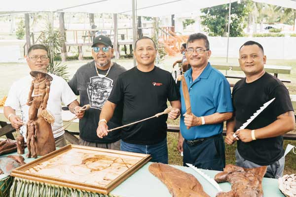 From right, Rota Municipal Council vice chair Jonovan H. Lizama, Rota Mayor Efraim Atalig, and RMC chair Jim M. Atalig hold up handmade tools and a sling during last weekend’s “2021 Gineptin Ha’anen Taga Festival” on Tinian.