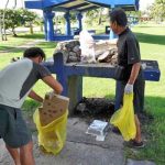 Hitoshi Yamaguchi, left, and Seiji Sato participate in a beach cleanup on Saipan on Sept. 27, 2021, in celebration of World Tourism Day