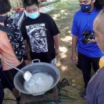Mike Naputi, right, teaches coconut oil making to students of Marianas Youth Welcome All Visitors Enthusiastically clubs of KHS
