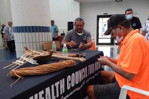 John Castro, middle, and a colleague make rope using coconut fibers.