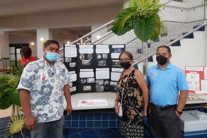NMI Museum of History and Culture docent Archie Ajoste, leftmost, shares a photo with colleagues at the museum’s table