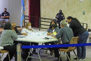 Commonwealth Election Commission executive director Kayla S. Igitol, rightmost, checks in on the CEC board last Saturday