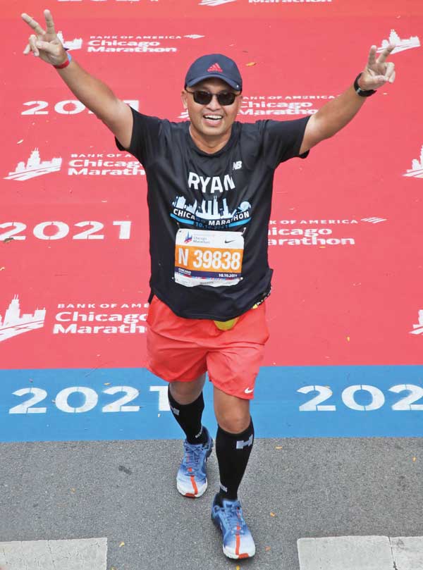 Diocese of Chalan Kanoa Bishop Ryan Jimenez crosses the finish line of the 2021 Bank of America Chicago Marathon last Oct. 10.
