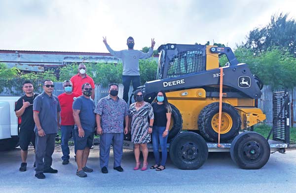 Turning over a $140,000 John Deere skid-steer loader to the motocross group.