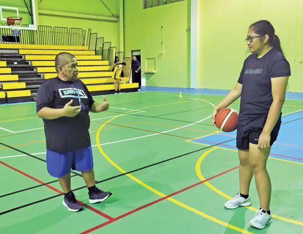 Coach Joe Diaz gives pointers to NMI National Team Program member Madi Alegre
