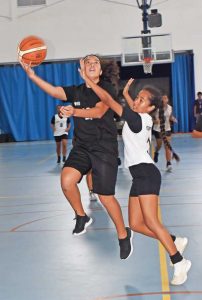 Marianas High School Varsity’s Kiana Rangamar takes a shot against the MHS Junior Varsity’s Nathanette Blas.