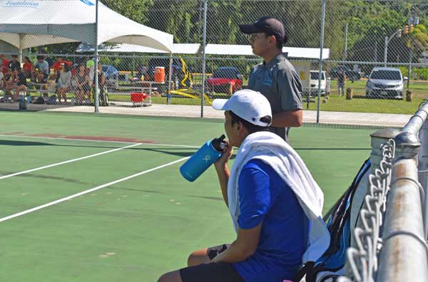 Jimin Woo, sitting, and Sam Ryu during a break in their boys 18-and-under championship