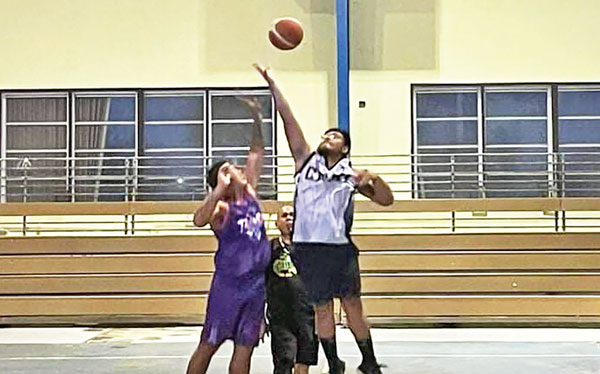 Team Kio’s Paka Sablan, left, and Team CNMI’s Estevan Borja contest the jump ball in midcourt