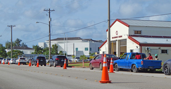 Community members line up in their cars for COVID-19 antigen testing