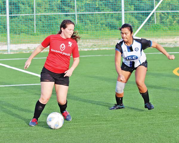 Paire Football Club 1’s Lindsay Davis, left, tries to maneuver her way out of the defense of MP United Football Club’s Amy Quito-Weiss