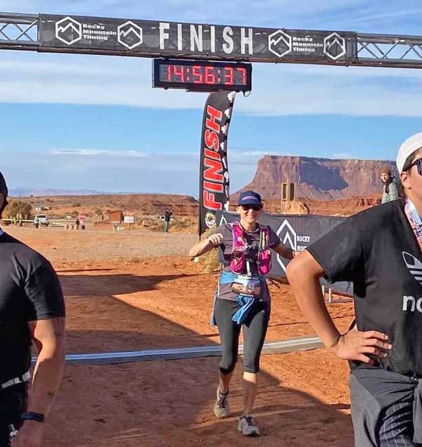 Lindsay Nash crosses the finish of the 2021 Monument Valley Veterans Marathon & Half Marathon