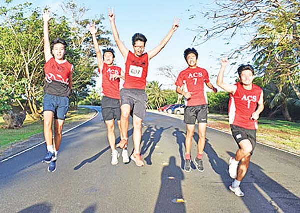 Agape Christian School A runners do the celebratory jump to the finish line