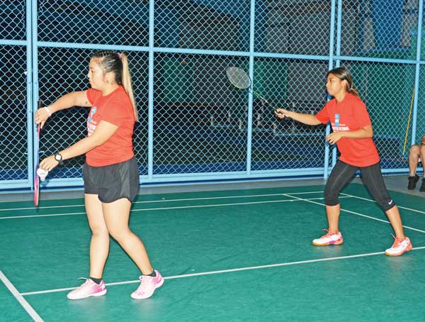 Janelle Pangilinan, left, prepares to serve, while Jen Savellano gets ready for the next play