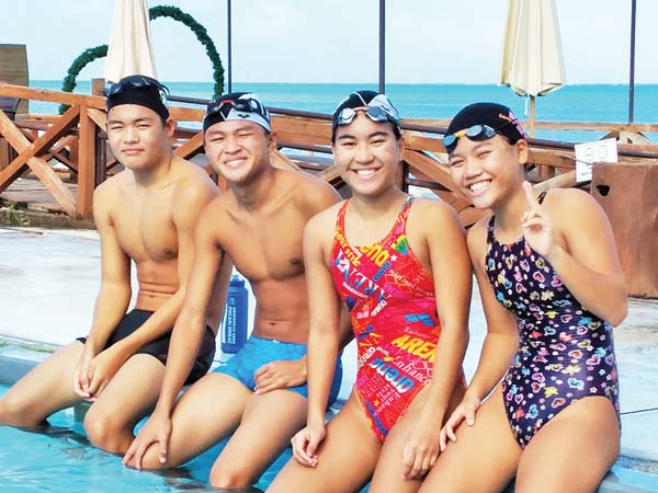 From left, CNMI national swimmers Jinnosuke Suzuki, Juhn Tenorio, and Asaka and Shoko Litulumar pose during a pause in practice at the Aqua Resort Club. 