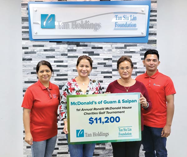 McDonald’s Guam and Saipan owner Marcia Ayuyu, third left, receives the ceremonial check donation for the inaugural RMHC Golf Tournament from TSL Foundation executive director Merlie Tolentino.