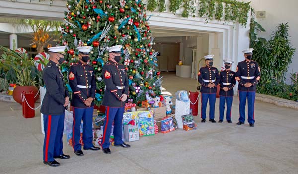 A contingent of U.S. Marines receive the donated toys at the Hyatt Regency Saipan.