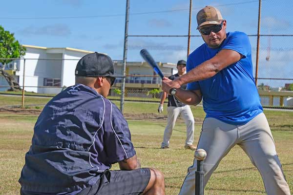 Jake Manuel practices his swing while Tritons Baseball head coach Roke Alcantara