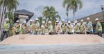 Men throwing shovels of sand.